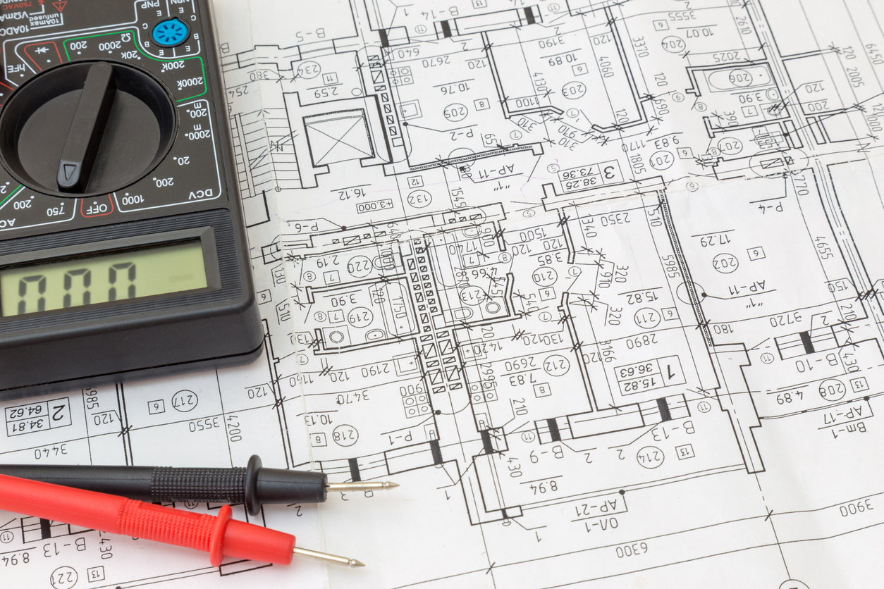 Still Life Of Electrical Components Arranged On Plans. Centered on testers (digital multimeters)